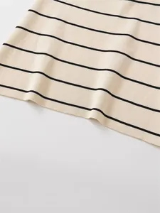 Detailed macro view of high-quality cream knit fabric featuring black horizontal stripes