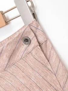 Detail of French style striped skirt waist with button and linen-like fabric texture