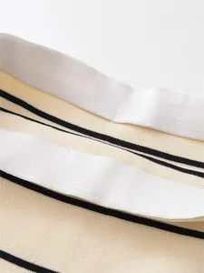 Detailed view of the elastic waistband on this elegant beige striped knit skirt