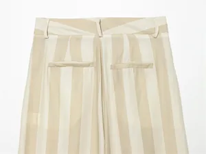 Gros plan sur la taille arrière et les poches passepoilées d'un pantalon large rayé