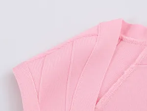 Detailed close-up of pink knitted vest showcasing high-quality ribbing and durable stitching