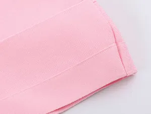 Macro close-up detail of premium high-elastic pink knitted fabric texture and hem finish