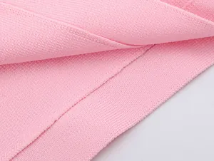Macro view of pink knitted fabric texture showing fine ribbing and soft material