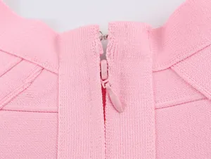 Close-up detail of a pink knitted vest featuring a hidden zipper and hook closure at the back