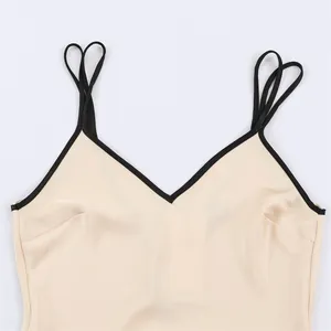 Close-up detail of V-neck dress with contrast trim and elegant double spaghetti straps.