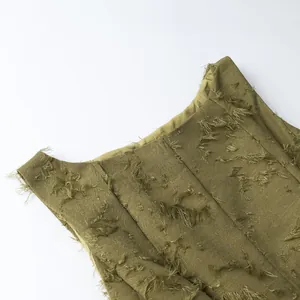 Detailed macro view of the olive green fringe jacquard fabric on a chic autumn top for women