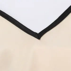 Detailed view of the V-neckline on a beige dress featuring black contrast piping.