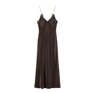 Brown satin slip dress with white contrast piping trim and V-neckline detail.