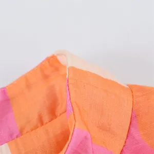 Close-up of pink and orange striped collar showing fabric texture and stitching