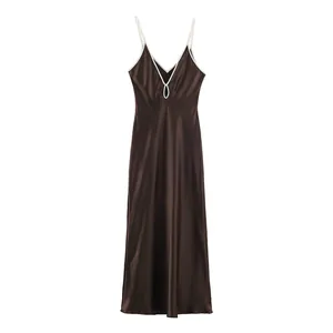 Close-up of elegant dark brown satin slip dress featuring delicate white contrast trim