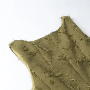 Close-up detail of olive green women's top featuring fringed jacquard fabric texture