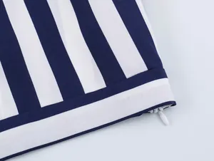 Detailed view of navy blue and white striped fabric showing a neat hidden zipper.