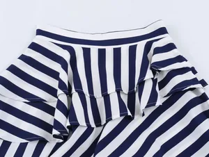 Detailed macro view of the blue and white striped ruffle layers on the asymmetric skirt