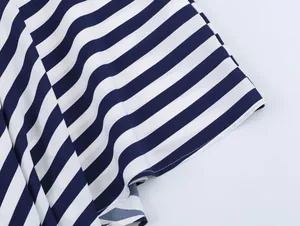 Detail of navy blue and white striped fabric with asymmetric hem for a vacation set.