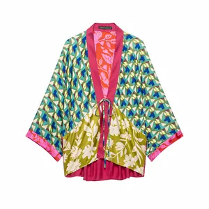 Detailed front view of a vibrant floral and geometric patchwork kimono style jacket