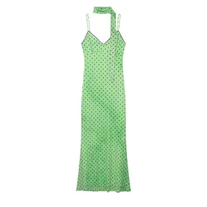 Elegant green polka dot slip dress with matching neck scarf and slim fit silhouette