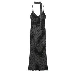 Detailed shot of a black tie-dye midi dress with spaghetti straps and a matching neck scarf
