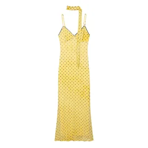 Elegant yellow polka dot maxi dress featuring a matching skinny neck scarf detail.