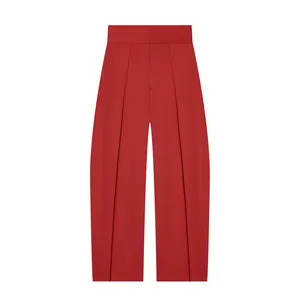Full length view of vibrant red high-waisted balloon trousers with elegant pleated design