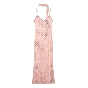Macro view showing the pink polka dot fabric and matching scarf of this summer dress