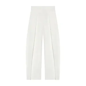 Close-up detail of white high-waisted balloon trousers featuring elegant front pleats