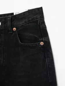 Detailansicht einer schwarzen High-Rise-Jeans mit Kupfernieten.