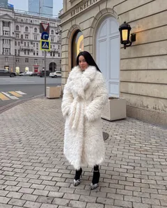 Elegant long white faux fur coat with shaggy texture for winter street style