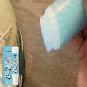 Close-up of white shoe cleaner stick removing stubborn stains from dirty footwear surface.