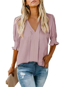 Detail of a mauve V-neck blouse with ruffled puff sleeves for stylish summer wear