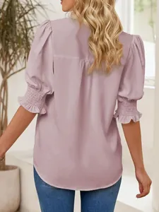 Close-up back view of a lavender puff sleeve blouse featuring smocked ruffled cuffs