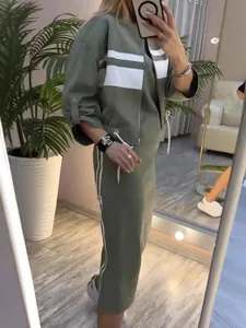 Detailed look at the olive green jacket and dress set with white side stripes