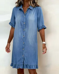 Detailed view of light blue denim shirt dress featuring ruffle hem and button-up front.