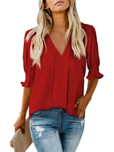 Detailed view of fashionable red V-neck short sleeve blouse with elegant puff cuffs and loose fit