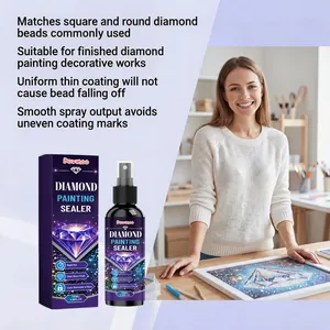 Woman applying diamond painting sealer spray to finished artwork in a bright studio