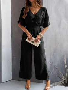 Elegant black short sleeve V-neck jumpsuit with wide leg design and belted waist