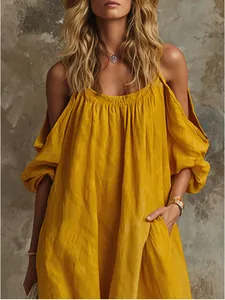 Detailed view of vibrant yellow cold-shoulder cotton linen maxi dress featuring casual side pockets