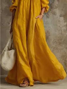 Detailed view of mustard yellow linen maxi dress with off-shoulder style and pockets