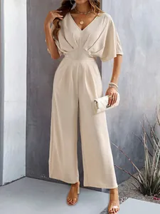 Elegant apricot short sleeve wide-leg jumpsuit for women shown in a lifestyle setting