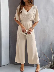 Elegant beige V-neck wide-leg jumpsuit with short sleeves on a fashion model