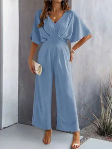 Elegant dusty blue short sleeve wide leg jumpsuit featuring V-neckline and cinched waistline