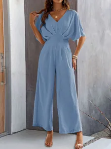 Elegant blue short-sleeve wide-leg jumpsuit with V-neck and waist-cinching detail.