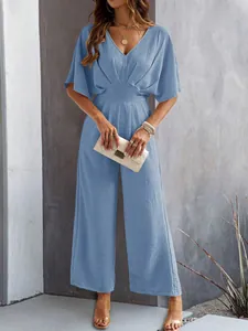 Elegant light blue wide-leg jumpsuit with short sleeves, V-neckline and textured fabric