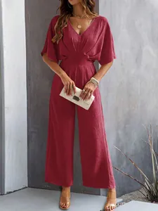 Elegant burgundy short sleeve wide-leg jumpsuit for women with stylish pleated texture.