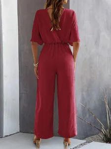 Back view of a stylish wine red short-sleeved wide-leg jumpsuit with waist detail