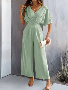Detail showing the textured fabric and waist design of this sage green wide-leg jumpsuit