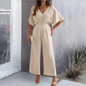 Elegant beige V-neck wide leg jumpsuit with short flutter sleeves and cinched waist for summer