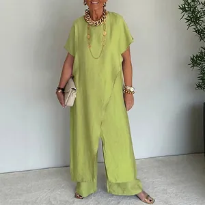 Elegante set da donna con tunica asimmetrica verde lime e pantaloni a gamba larga