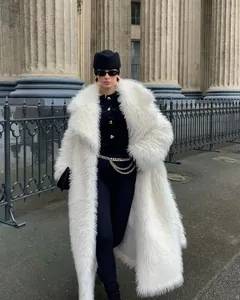 Full-length white faux fur coat worn by a model in chic winter street style fashion