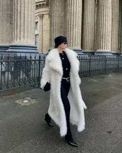 Stylish long white faux fur coat for women in luxury European street style winter fashion.
