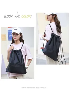 High-quality black oxford cloth drawstring gym backpack with front zipper pocket on model